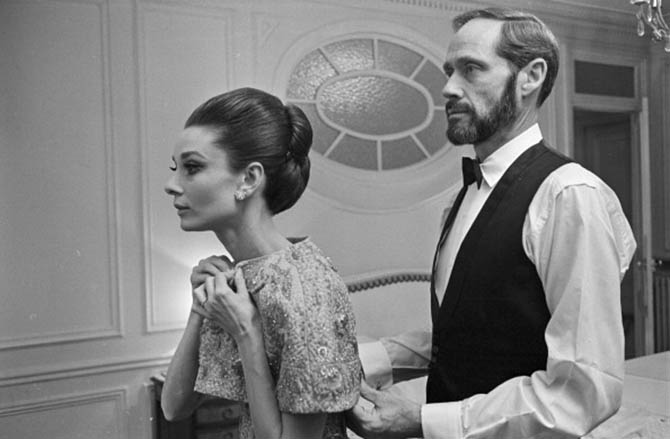 Mel Ferrer with Audrey Hepburn who is wearing one of her wedding bands. The couple is getting ready to attend the 1964 Paris premiere of Hepburn's film 'My Fair Lady.'