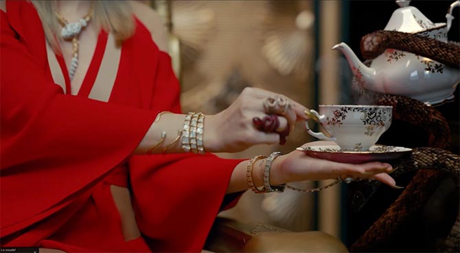 Detail of Taylor Swift showing a Bulgari Serpenti necklace and bracelets as well as rings and bracelets by Borgioni and Lydia Courteille