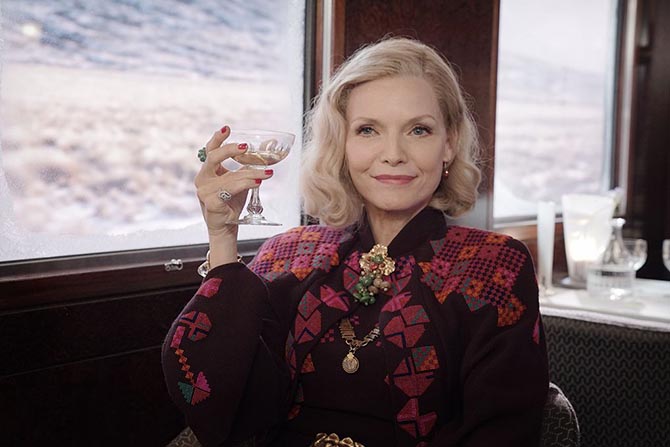 Gold jewelry and a couple of gemmy rings highlight Michelle Pfeiffer's costume in 'Murder on the Orient Express. Photo Twentieth Century Fox