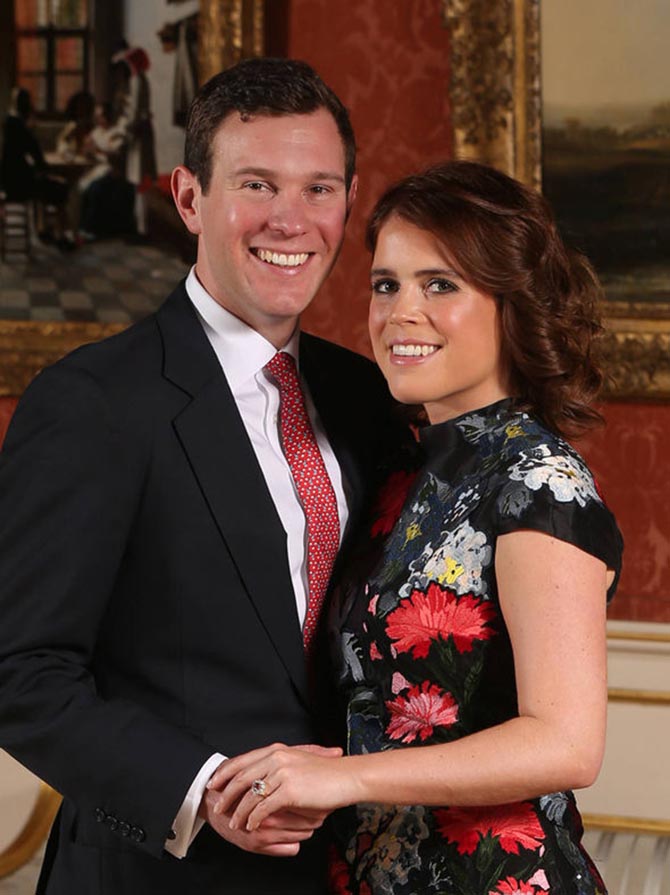At Buckingham Palace on January 22, 2018 for the formal announcement of their engagement, Jack Brooksbank poses with Princess Eugenie of York who displays her Padparadscha sapphire and diamond engagement ring Photo Getty