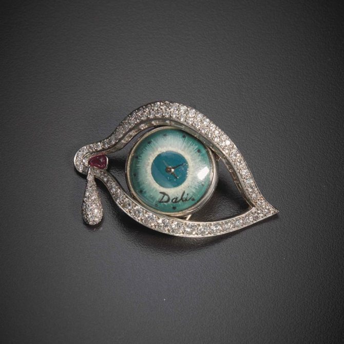 Dalí's pavé-set diamond and platinum Eye of Time brooch has baguette-cut diamonds set along the lid, a diamond tear drop pendant and a ruby at the lacrimal sac. The dial of the watch was hand painted and signed by Dalí. Movado was responsible for the mechanical movement. Photo Sotheby's