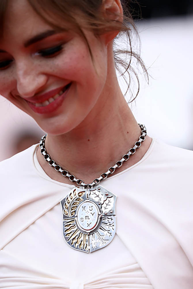Detail of Louise Bourgoin wearing a dramatic shield necklace by Elie Top.