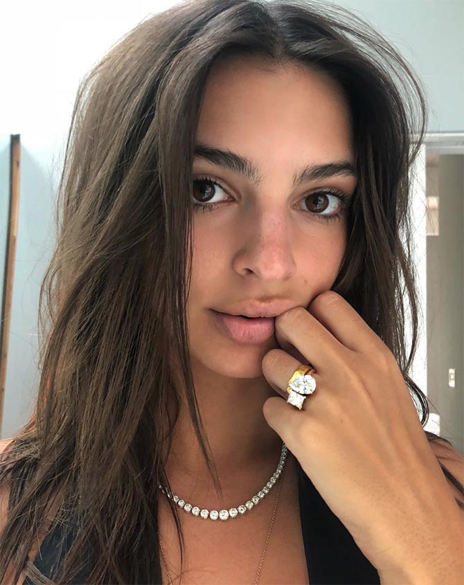 Emily Ratajkowski posing with her engagement ring and a diamond necklace. Photo via @emrata/Instagram