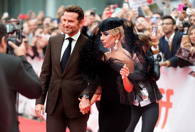Bradley Cooper and Lady Gaga wearing Chopard earrings at the "A Star Is Born" premiere during 2018 Toronto International Film Festival