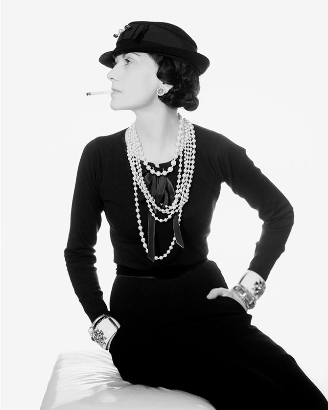Coco Chanel wearing her Maltese Cross Cuffs and pearl Fleuron bracelet designed by Verdura among other jewels in 1935. Photo Man Ray
