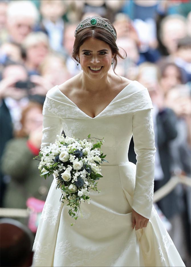 Princess Eugenie entering the St. George's Chapel wearing the the Greville Emerald Kokoshnik Tiara and emerald and diamond earrings. Photo Getty