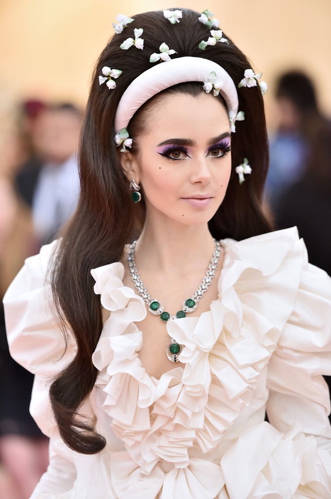 Lily Collins wore a Cartier emerald, rock crystal, onyx, black lacquer and diamond and platinum necklace from the new Magnitude High Jewelry collection.