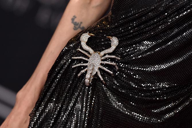 Detail of Angelina Jolie wearing a 50-carat diamond scorpion brooch she designed with Robert Procop at the World Premiere of 'Maleficent: Mistress of Evil' at El Capitan Theatre on September 30, 2019 in Los Angeles. Photo Getty
