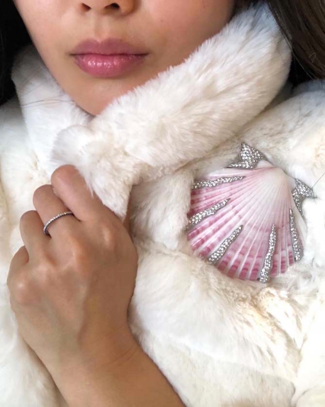 Christine Cheng bundled up in a Taffin ring and Verdura shell from Simon Teakle. Photo via Instagram @christinechengny