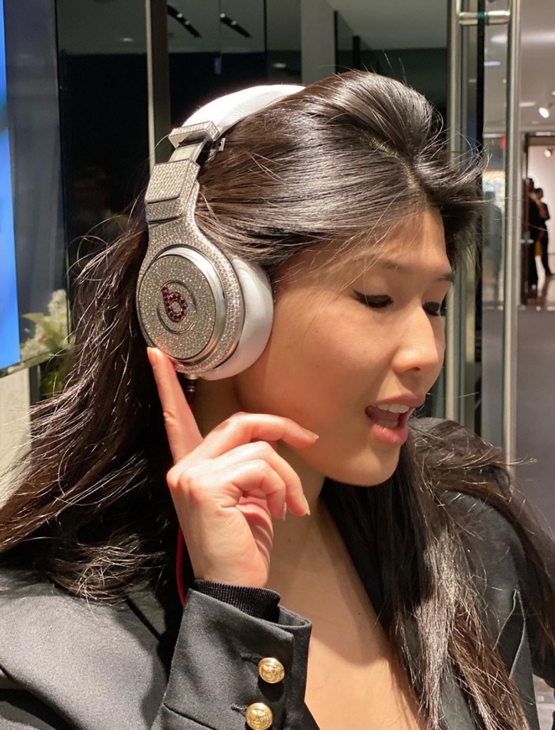 Christine Cheng trying on the Beats Pro Headphones decorated with diamonds by Graff at Christie's. Photo via Instagram @christinechengny