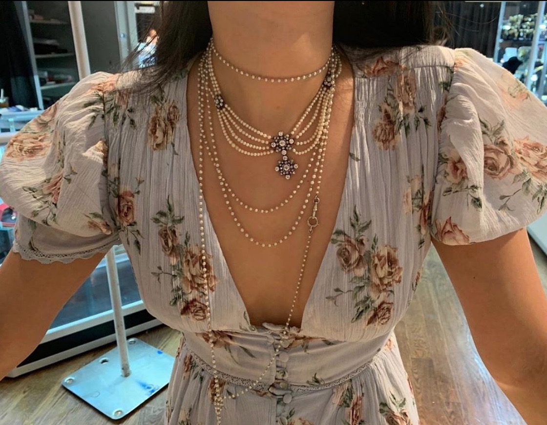 Christine Cheng wearing ropes of pearls at an Antiques Show. Photo via Instagram @christinechengny